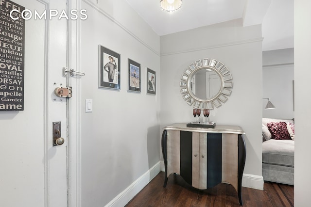 hallway with baseboards and wood finished floors