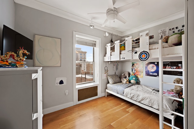 bedroom featuring ornamental molding, baseboards, and light wood finished floors