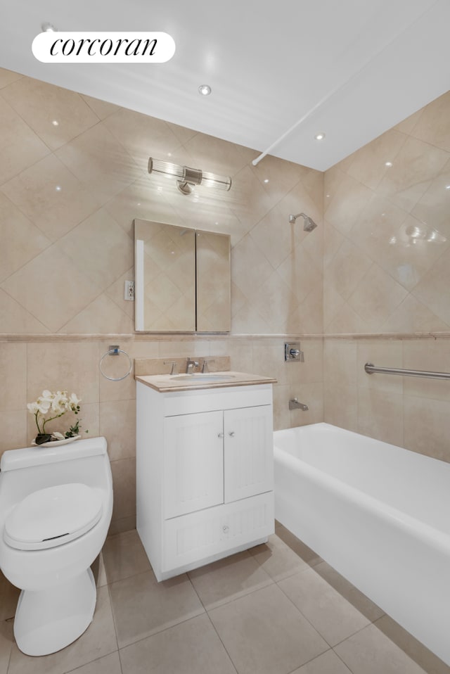 bathroom featuring tile patterned flooring, toilet, vanity, bathing tub / shower combination, and tile walls