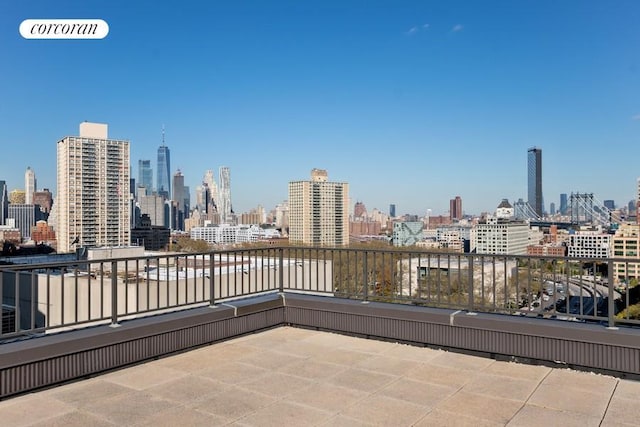 view of patio / terrace featuring a view of city and a balcony