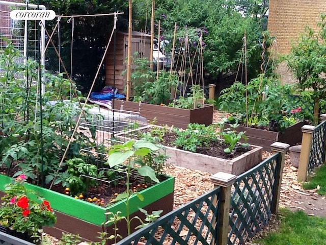 view of yard with a vegetable garden and fence