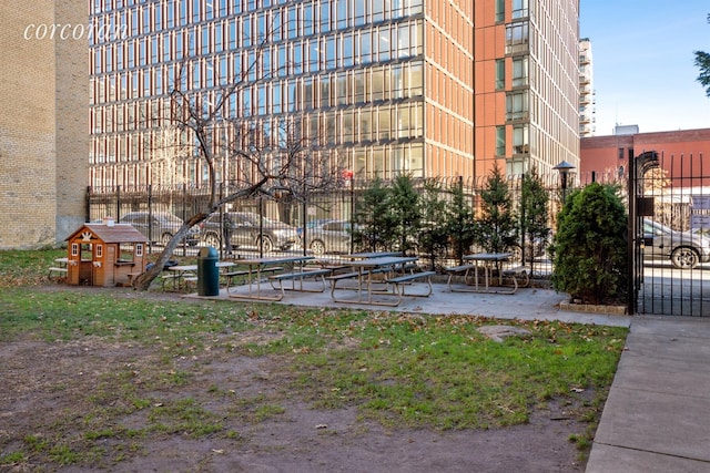 view of home's community featuring fence