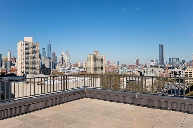 view of patio / terrace with a view of city and a balcony