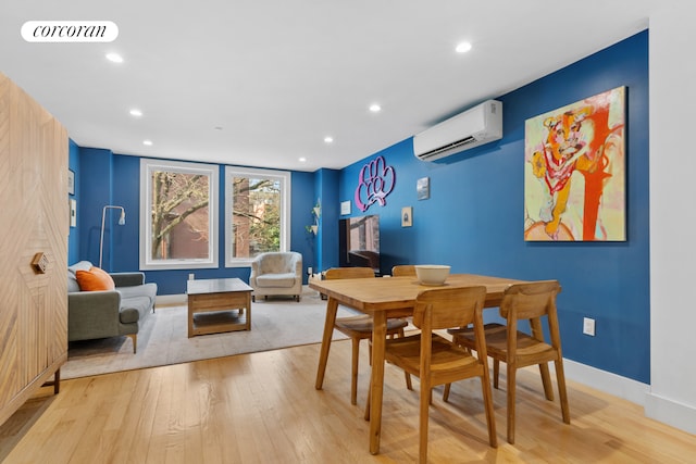 dining area featuring light wood finished floors, visible vents, recessed lighting, and a wall unit AC