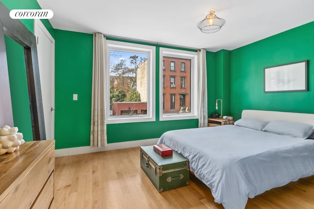 bedroom featuring baseboards and wood finished floors