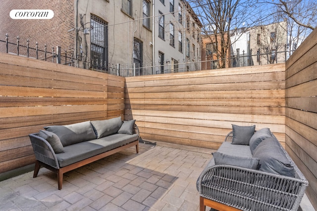 view of patio featuring fence and an outdoor hangout area