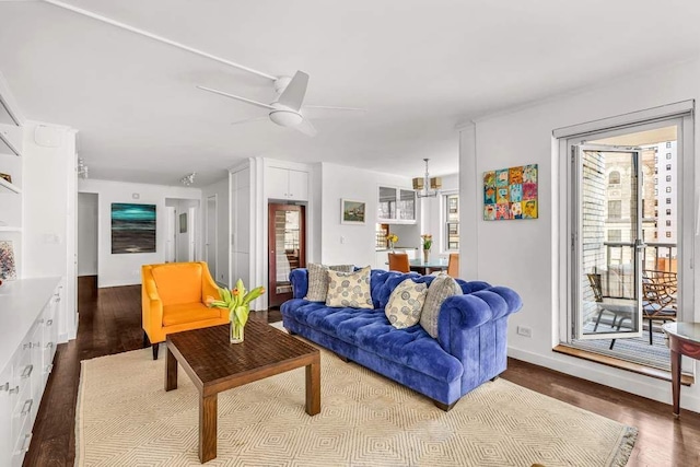 living area with dark wood finished floors and ceiling fan