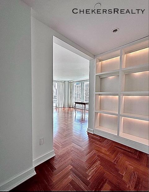 unfurnished room with baseboards