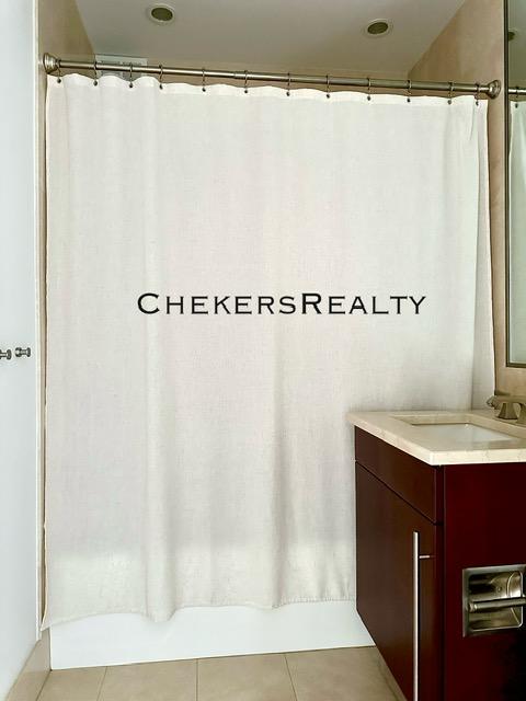 bathroom with a shower with curtain, vanity, and tile patterned flooring