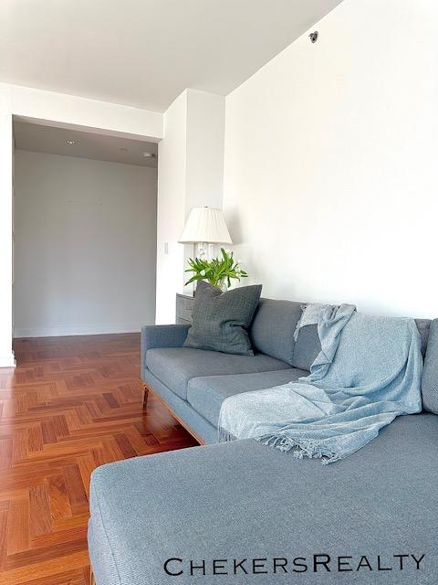 living area featuring baseboards