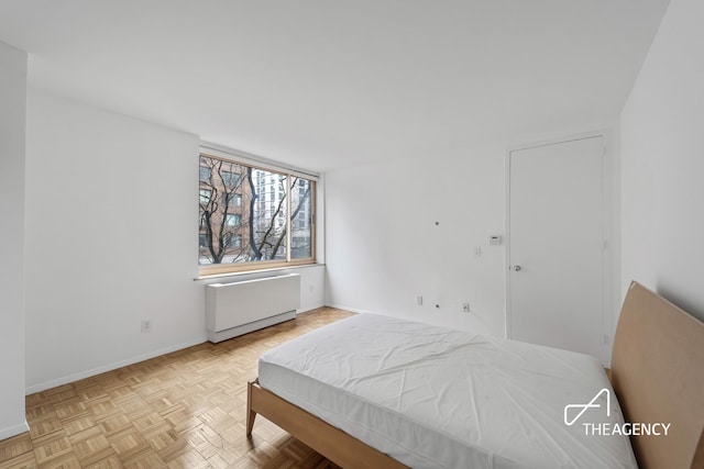 bedroom featuring radiator and baseboards