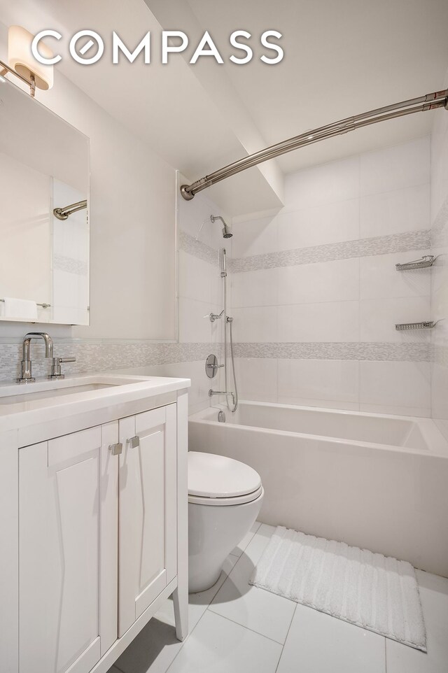 full bath with shower / bathing tub combination, tile patterned flooring, vanity, and toilet