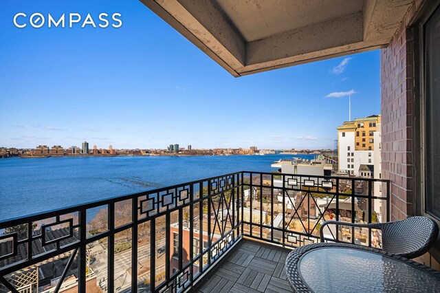 balcony featuring a city view and a water view