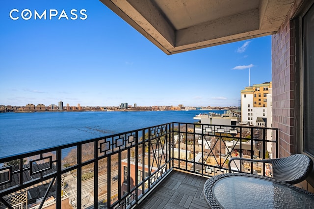 balcony with a view of city and a water view
