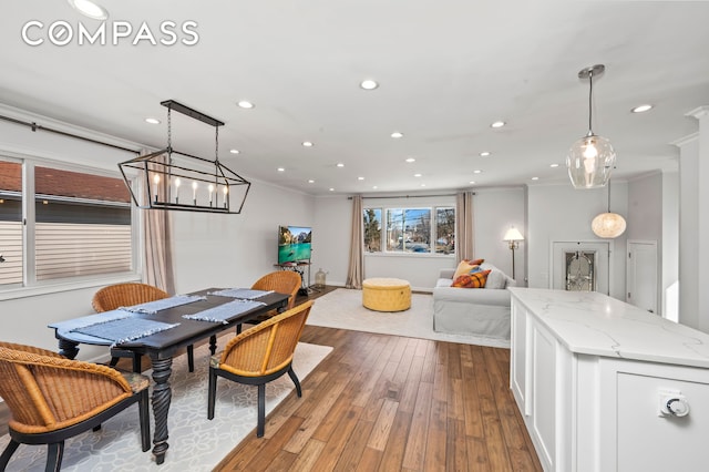 dining area featuring dark wood finished floors, crown molding, recessed lighting, and baseboards