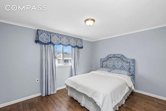 bedroom featuring hardwood / wood-style floors, crown molding, and baseboards