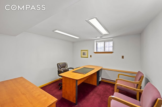 office space featuring dark colored carpet, visible vents, and baseboards