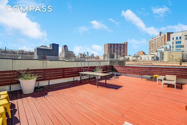 wooden terrace featuring a city view