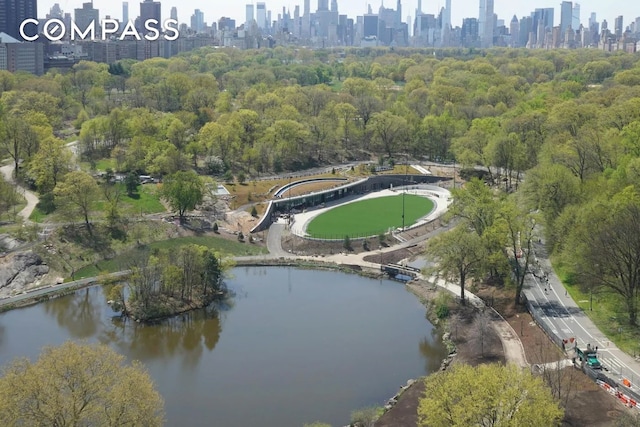 birds eye view of property featuring a view of city and a water view