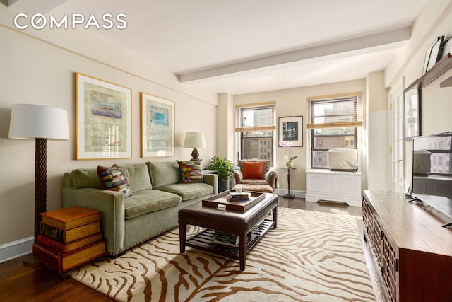 living room featuring beamed ceiling, wood finished floors, and baseboards