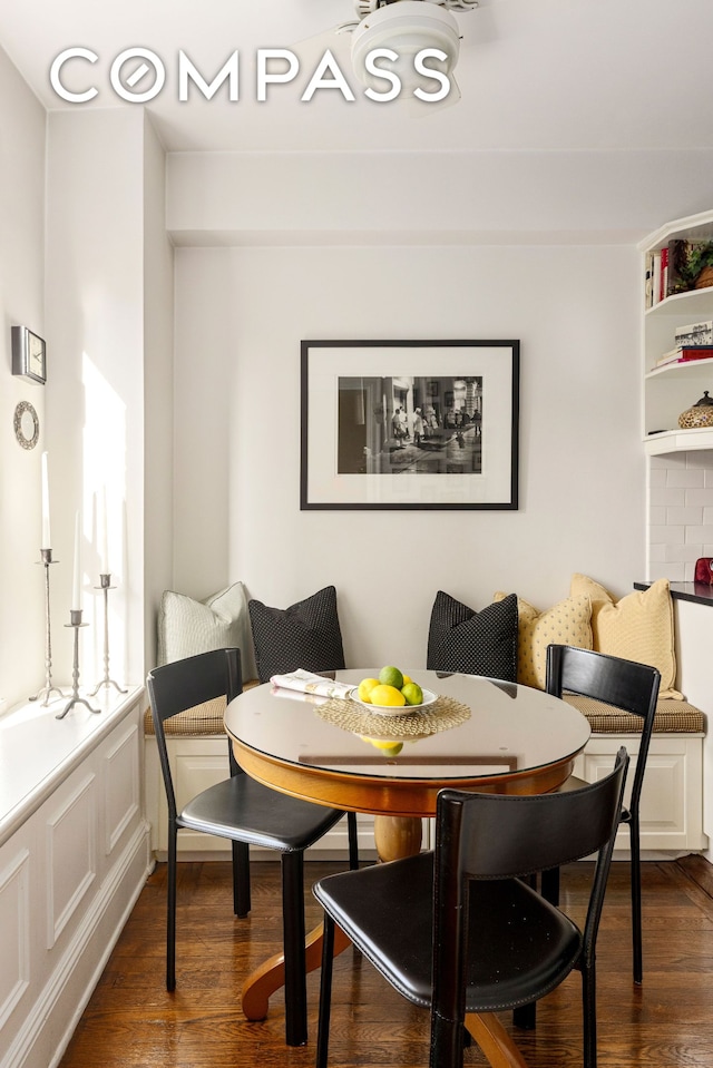 dining area with dark wood-style floors and breakfast area