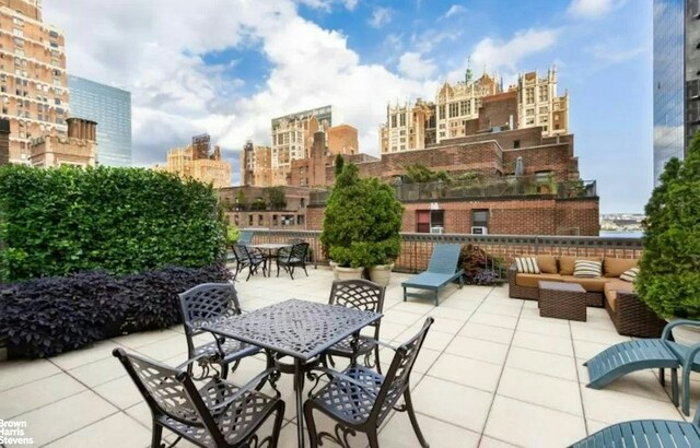 view of patio with a view of city, outdoor dining area, and outdoor lounge area