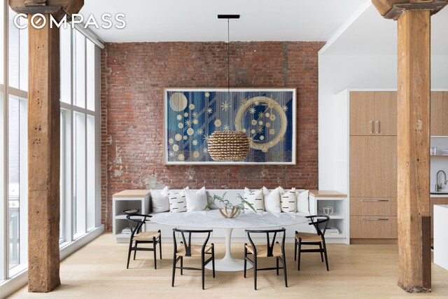 living room featuring a wall of windows, wood finished floors, and a healthy amount of sunlight