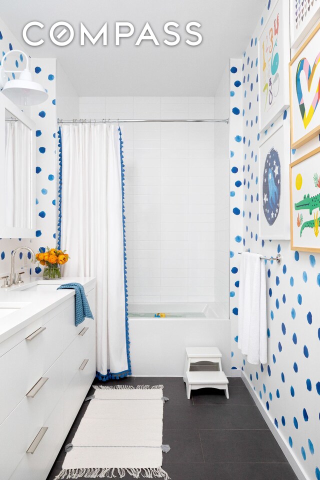 full bathroom featuring wallpapered walls, vanity, and shower / bath combo