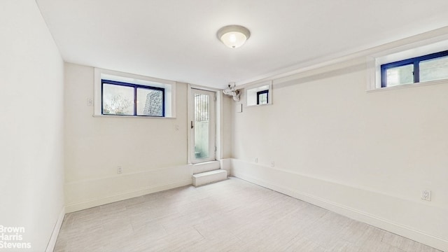 empty room featuring baseboards and wood finished floors