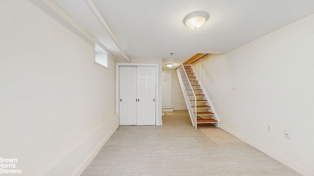 finished basement with stairs and baseboards