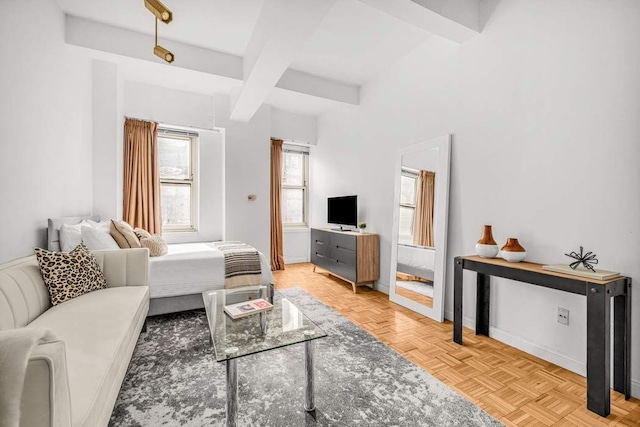 bedroom featuring beamed ceiling and baseboards