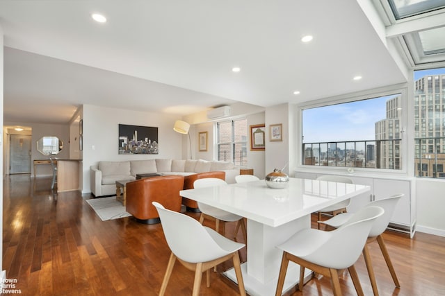 dining room with an AC wall unit, baseboards, dark wood-style floors, and a healthy amount of sunlight