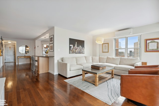 living area featuring dark wood-type flooring, a wall mounted air conditioner, and baseboards