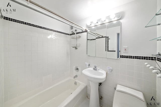 211 Thompson St Unit 4-C, New York City, NY 10012 - full bathroom featuring shower / bath combination, toilet, and tile walls