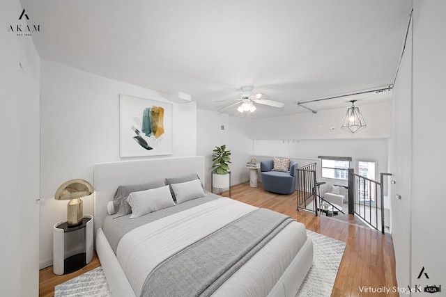 bedroom with ceiling fan and light wood-type flooring