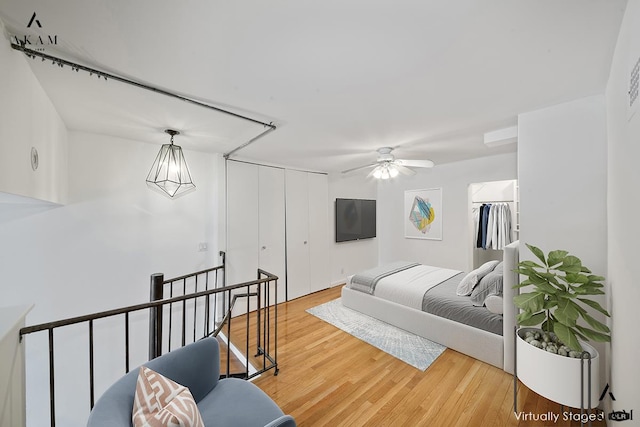 bedroom with ceiling fan, a closet, and wood finished floors