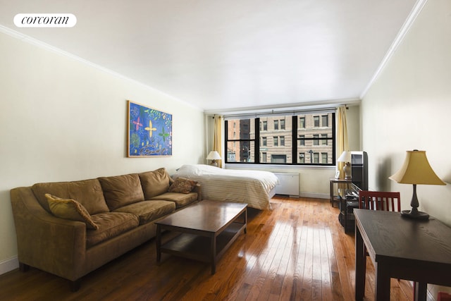 bedroom featuring hardwood / wood-style flooring, baseboards, visible vents, and crown molding