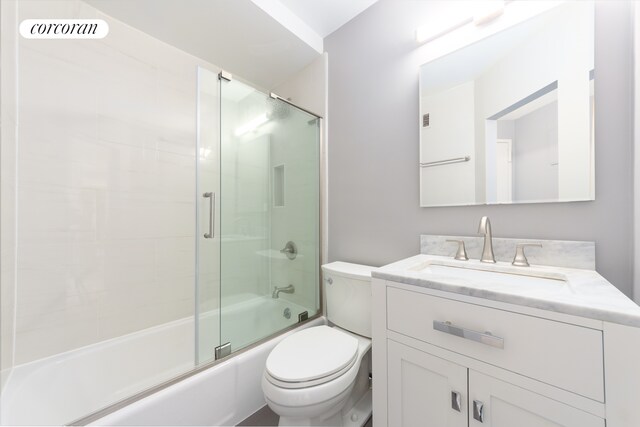 bathroom featuring visible vents, toilet, vanity, and shower / bath combination with glass door