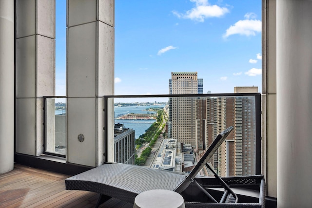 balcony featuring a view of city and a water view