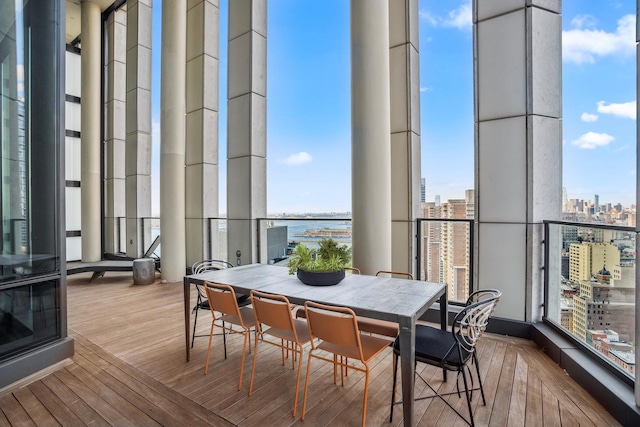 sunroom with a water view and a city view