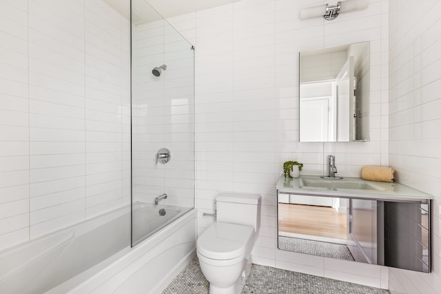 bathroom featuring tile patterned flooring, tile walls, toilet, and shower / bath combination