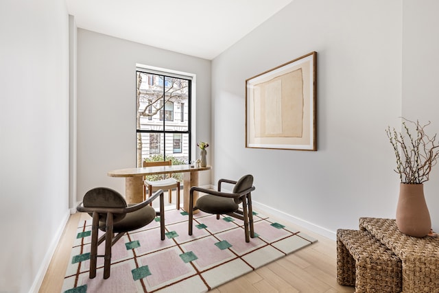 living area featuring baseboards and wood finished floors