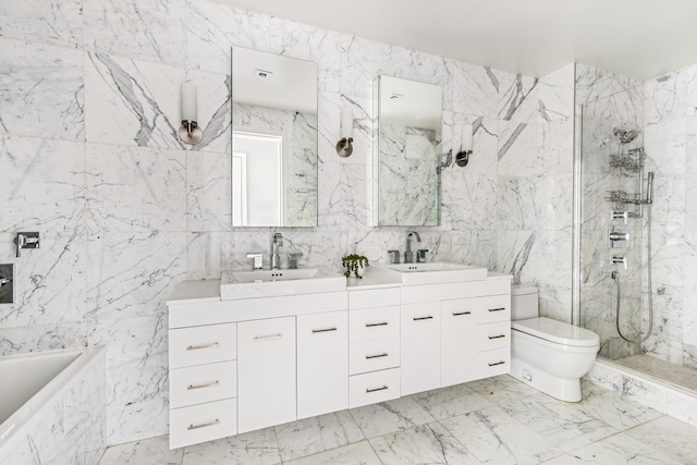 bathroom featuring a marble finish shower, double vanity, toilet, and a sink