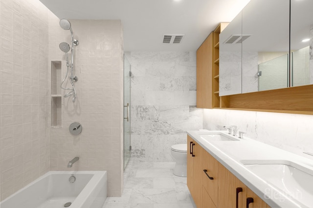 bathroom with visible vents, toilet, marble finish floor, a sink, and double vanity