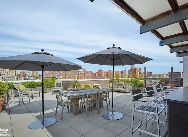 view of patio / terrace with a view of city and outdoor dining area