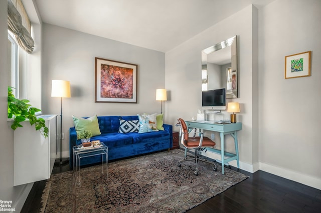 living room with baseboards and wood finished floors