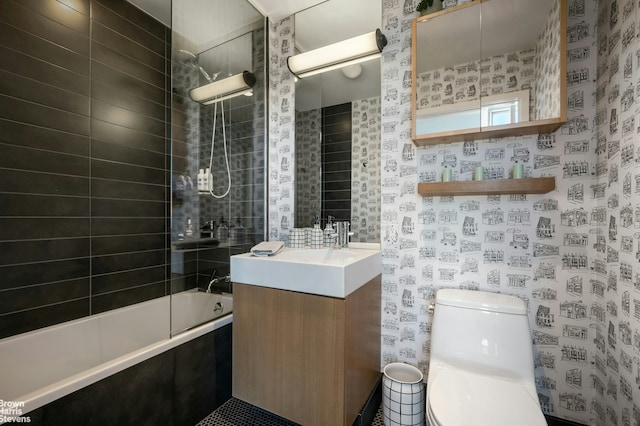 full bathroom with toilet, wallpapered walls, vanity, and shower / bathing tub combination