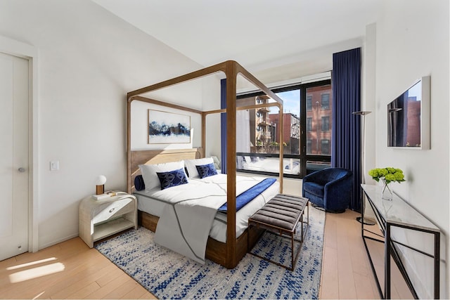 bedroom featuring access to outside and hardwood / wood-style floors