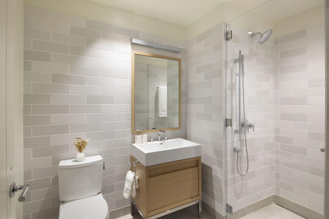 full bath with vanity, a shower stall, and toilet