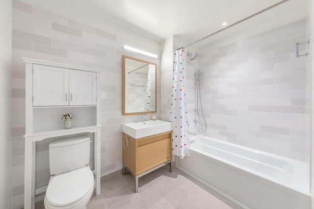 full bathroom featuring tile patterned flooring, vanity, toilet, and shower / bath combo with shower curtain